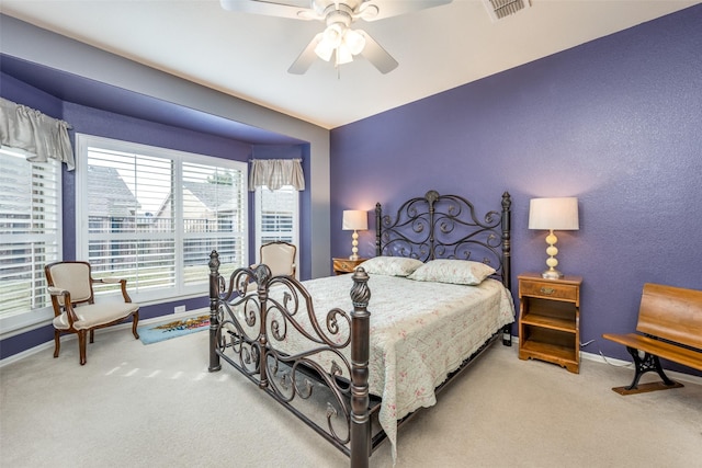 bedroom featuring ceiling fan and carpet