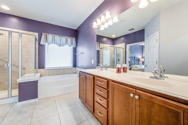 bathroom featuring tile patterned floors, vanity, and shower with separate bathtub