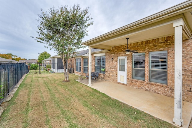 view of yard featuring a patio and ceiling fan