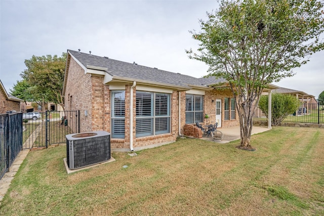 back of property featuring a patio area, central air condition unit, and a yard