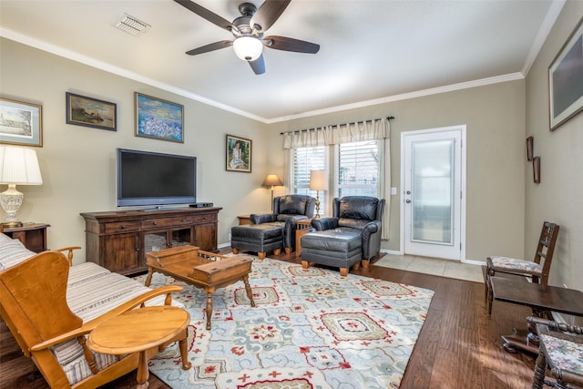 living room with hardwood / wood-style floors, ceiling fan, and ornamental molding