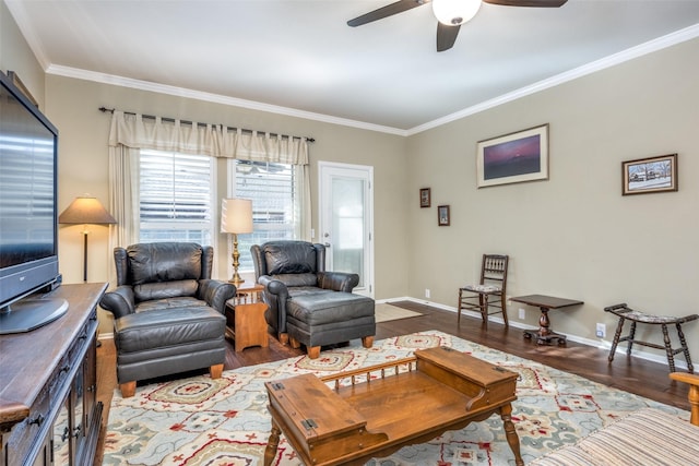 living room with crown molding, ceiling fan, and dark hardwood / wood-style floors