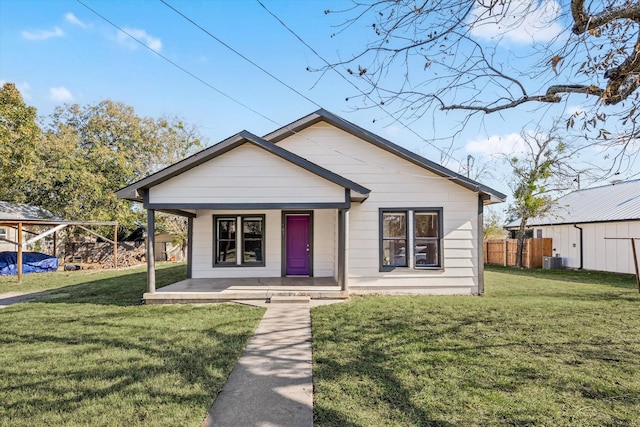 bungalow-style house with central AC, a porch, and a front yard