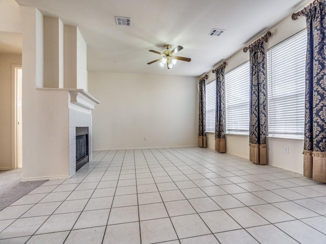 unfurnished living room featuring ceiling fan and light tile patterned flooring