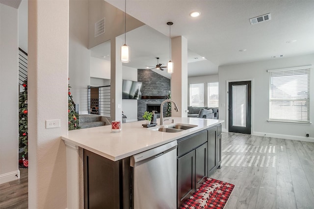 5214 Rowlan Row, Midlothian, TX 76065 - kitchen featuring dishwasher, ceiling fan, a fireplace, open floor plan, and light wood-style floors