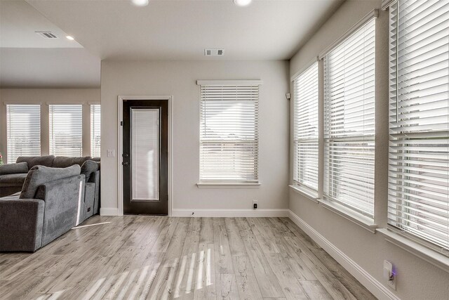 foyer with plenty of natural light and light hardwood / wood-style floors