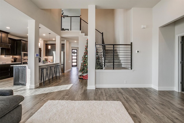 entrance foyer featuring a high ceiling, light hardwood / wood-style floors, and sink