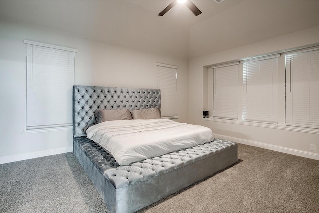 bedroom featuring lofted ceiling, dark carpet, and ceiling fan