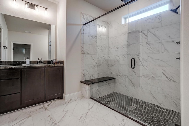 bathroom with walk in shower and vanity