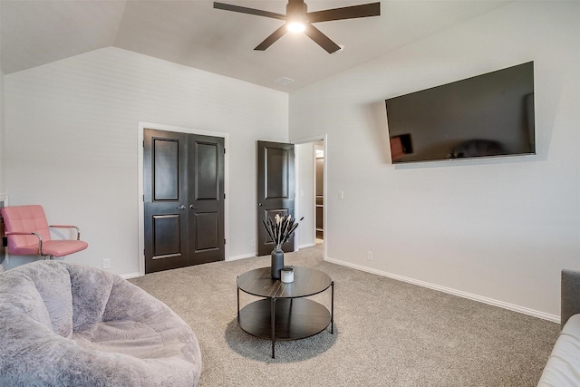 living room featuring lofted ceiling, carpet floors, and ceiling fan