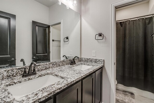 5214 Rowlan Row, Midlothian, TX 76065 - bathroom featuring double vanity and curtained shower