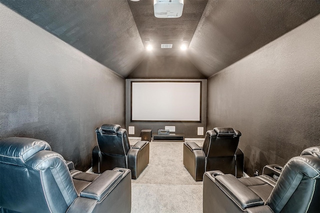 carpeted cinema featuring a textured ceiling and vaulted ceiling