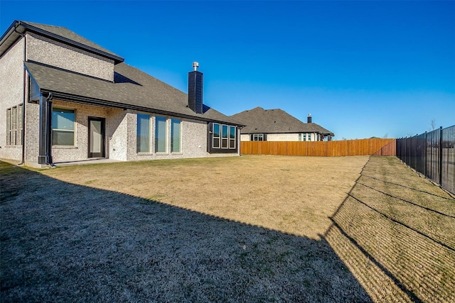 back of house featuring a yard