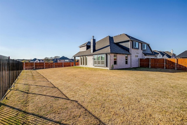 rear view of property with a yard