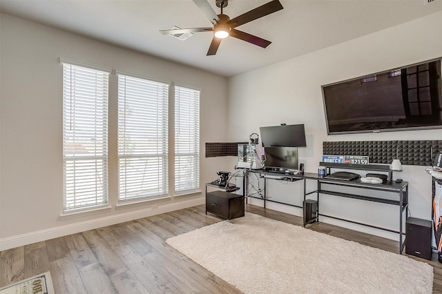 home office featuring ceiling fan and light hardwood / wood-style flooring