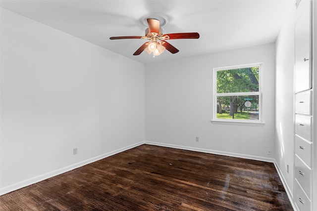 spare room featuring dark hardwood / wood-style floors and ceiling fan