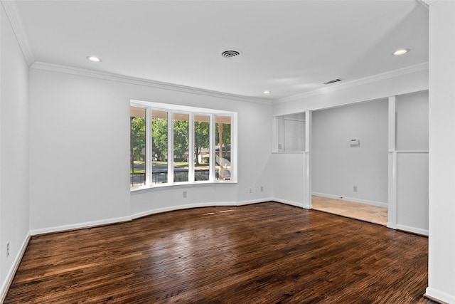 spare room featuring crown molding and dark wood-type flooring