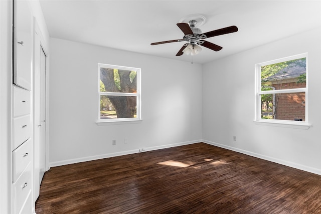 unfurnished bedroom with dark hardwood / wood-style floors, multiple windows, and ceiling fan