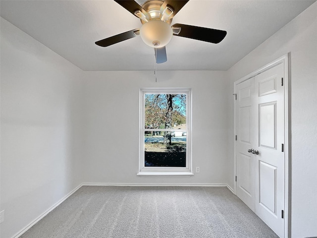 spare room featuring ceiling fan and carpet floors