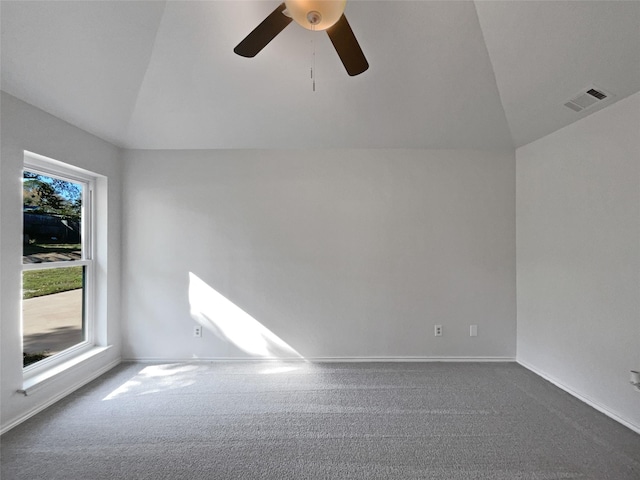 carpeted spare room with vaulted ceiling and ceiling fan