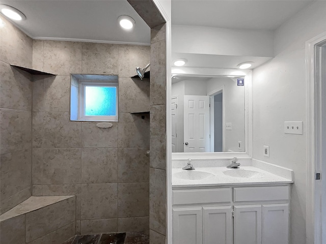 bathroom with vanity and tiled shower