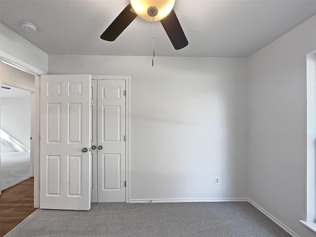 unfurnished bedroom with ceiling fan, a closet, and wood-type flooring