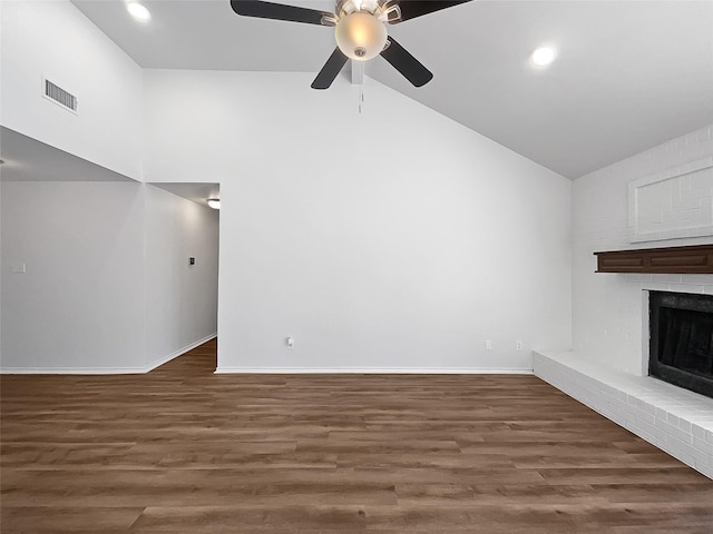 unfurnished living room with a fireplace, high vaulted ceiling, ceiling fan, and dark wood-type flooring