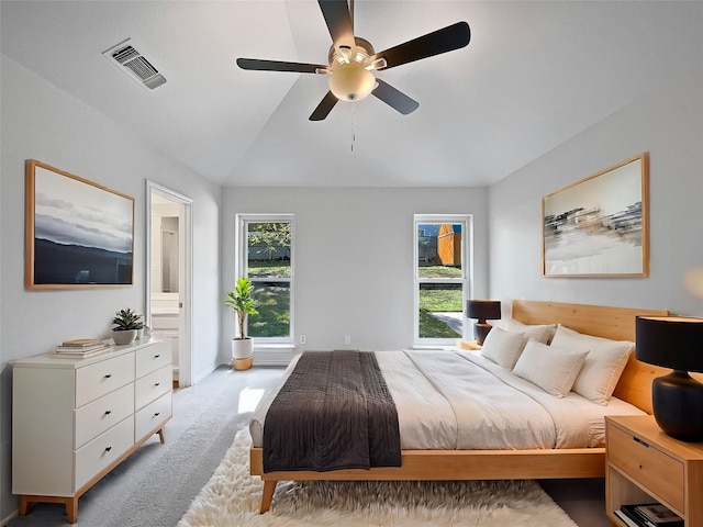 carpeted bedroom with ceiling fan and vaulted ceiling