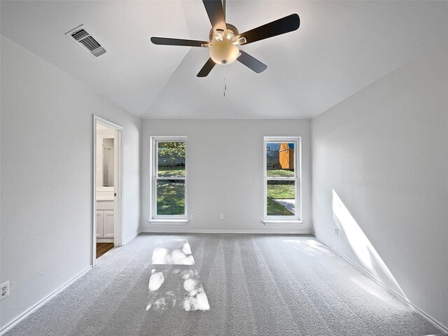 carpeted empty room featuring ceiling fan and lofted ceiling