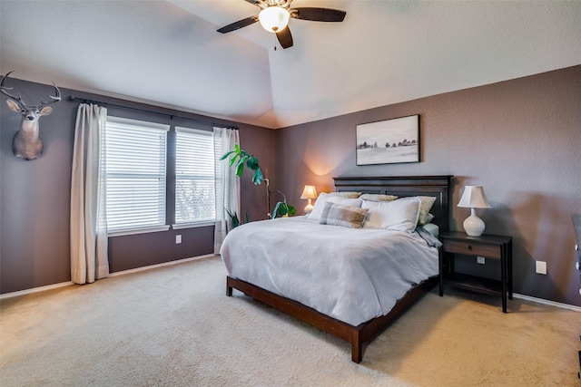 bedroom with ceiling fan, light carpet, and lofted ceiling