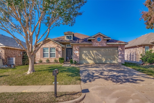 view of front of home featuring a garage and a front lawn