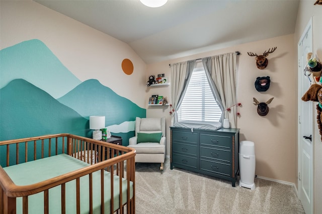 carpeted bedroom with a crib and vaulted ceiling