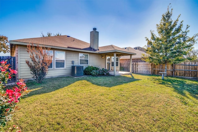 back of property featuring a lawn, a patio area, and central AC