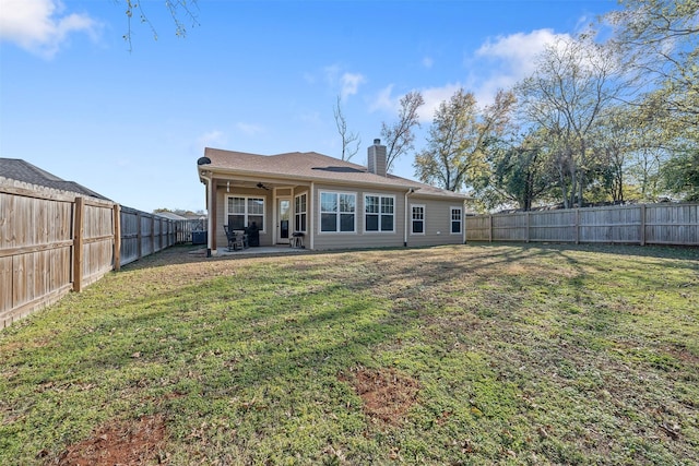 back of property featuring ceiling fan, a patio area, and a lawn