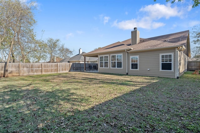 back of house featuring a lawn