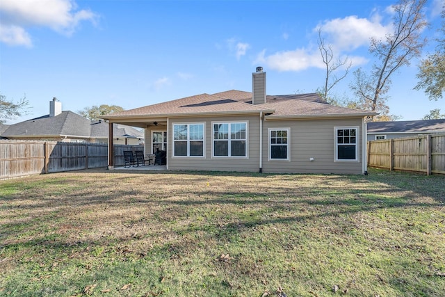 back of house with a lawn, a patio area, and ceiling fan