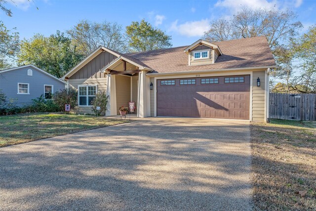 view of front of house featuring a front yard and a garage