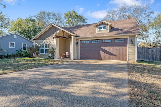 view of front of property with a garage and a front yard