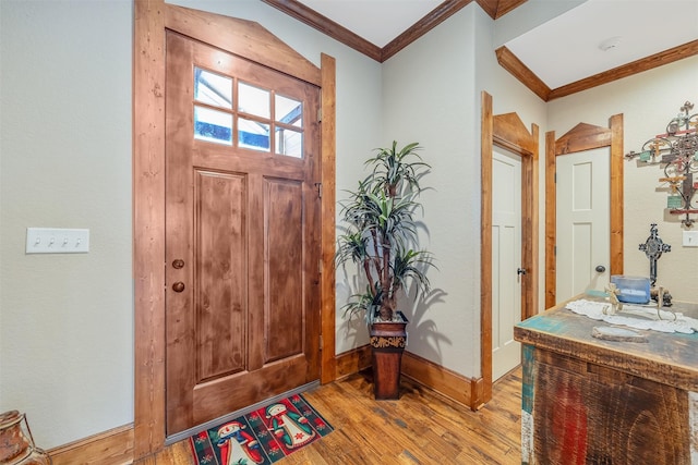 foyer entrance featuring light wood-type flooring and crown molding