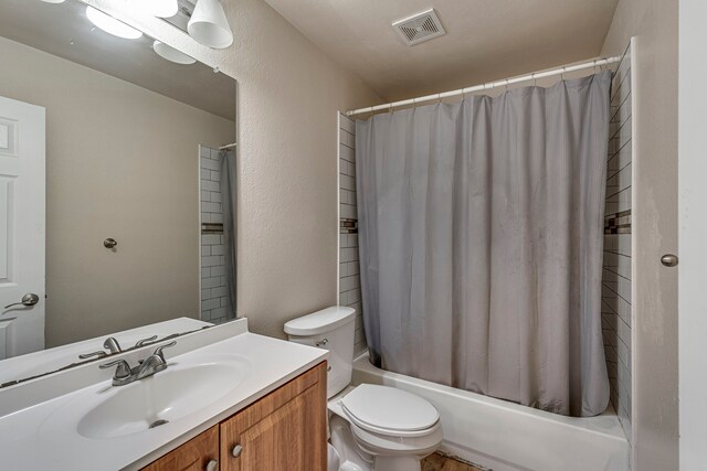 full bathroom with vanity, shower / bath combination with curtain, and toilet