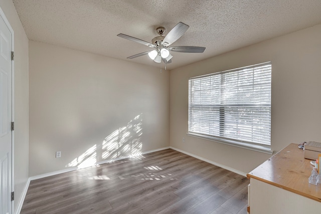 interior space featuring wood-type flooring, a textured ceiling, and ceiling fan