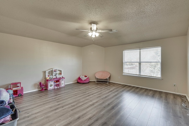 rec room featuring ceiling fan, a textured ceiling, and light hardwood / wood-style flooring