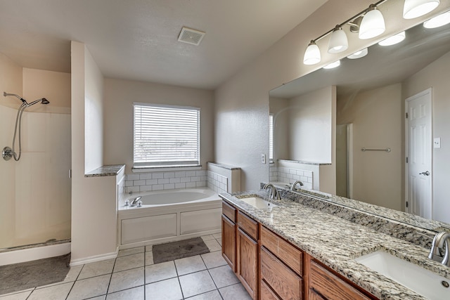 bathroom with tile patterned floors, vanity, and shower with separate bathtub