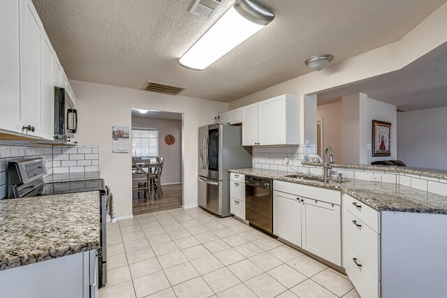 kitchen with white cabinetry, sink, and appliances with stainless steel finishes