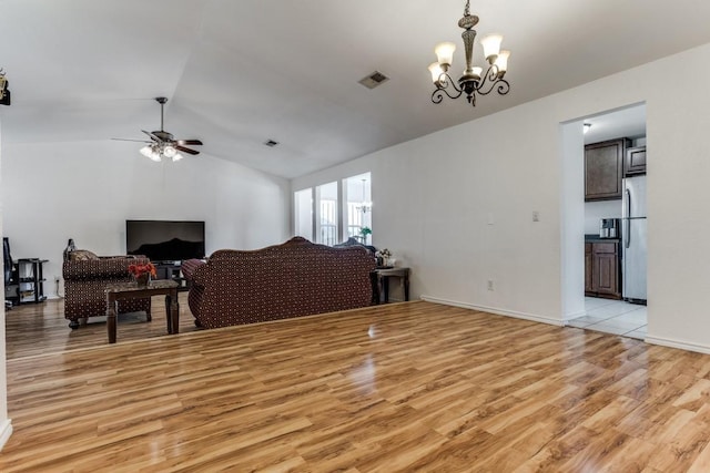 living room featuring ceiling fan with notable chandelier, light hardwood / wood-style floors, and lofted ceiling