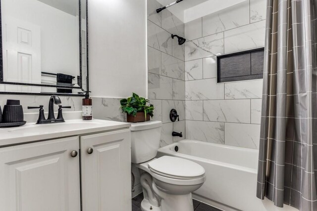 full bathroom featuring vanity, toilet, and shower / bathtub combination with curtain