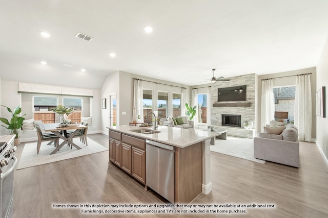 kitchen with plenty of natural light, sink, stainless steel appliances, and a kitchen island with sink