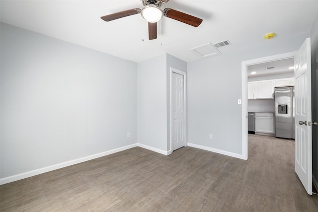 empty room featuring ceiling fan and light hardwood / wood-style floors