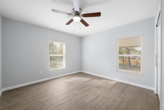 spare room with ceiling fan, plenty of natural light, and hardwood / wood-style flooring