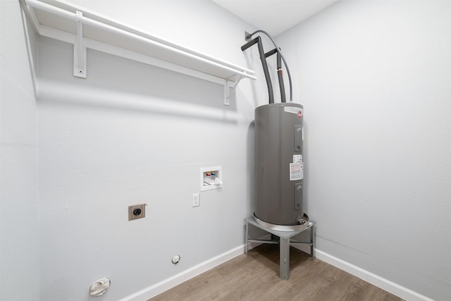 washroom featuring hardwood / wood-style floors, electric water heater, hookup for a gas dryer, hookup for a washing machine, and hookup for an electric dryer